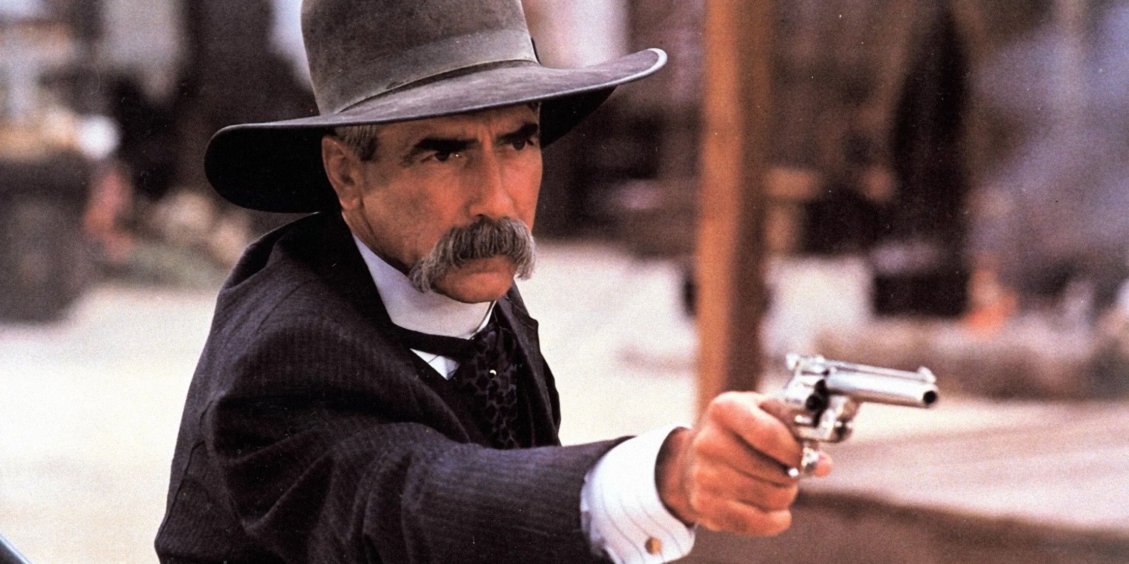 Sam Elliott as Virgil Earp aiming a gun in Tombstone