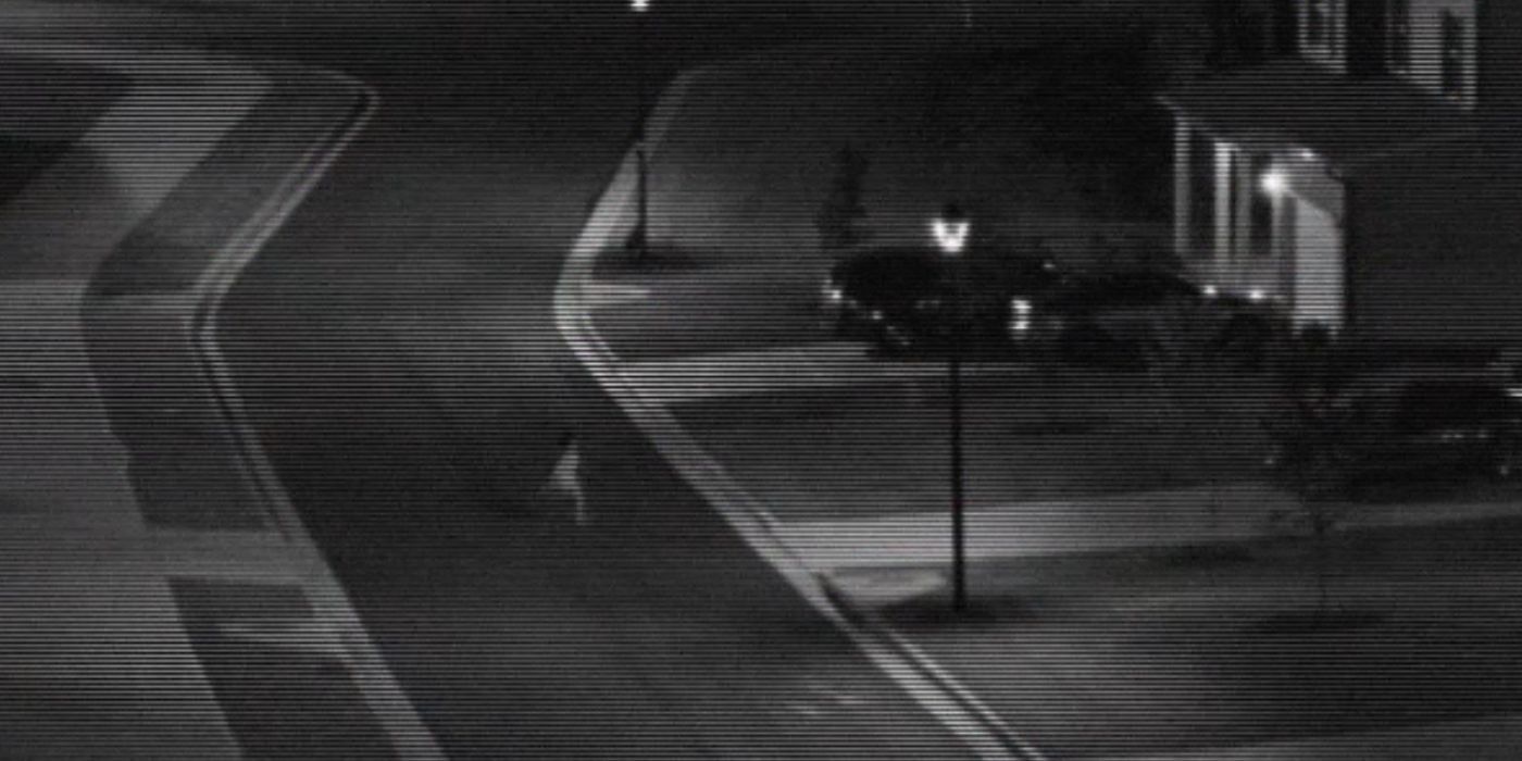 A child is caught on black and white surveillance footage running across the street of a quiet suburban neighborhood alone at night.