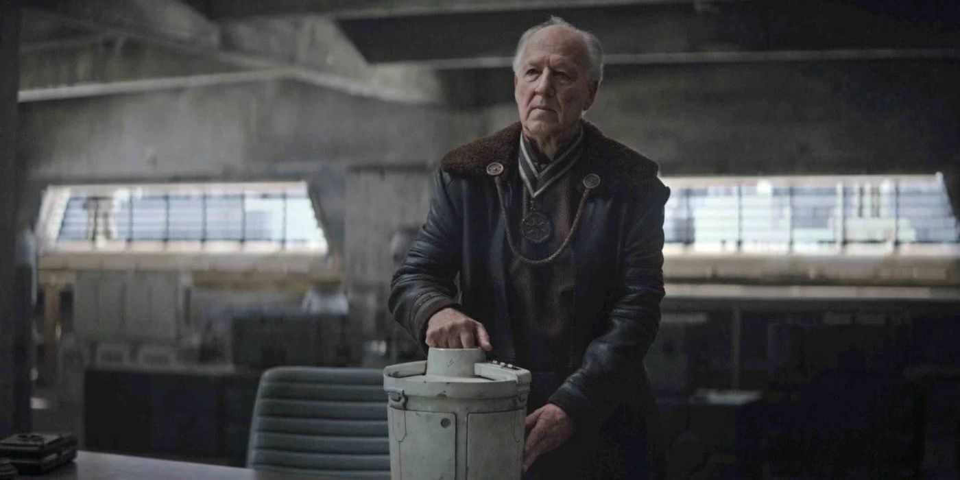 Werner Herzog as The Client, holding onto an object and looking determined in The Mandalorian.