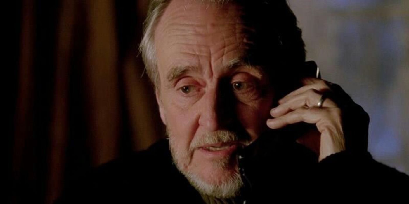 Director Wes Craven talks on a phone as himself in Castle season 5, episode 17, &ldquo;Scared to Death&rdquo;.