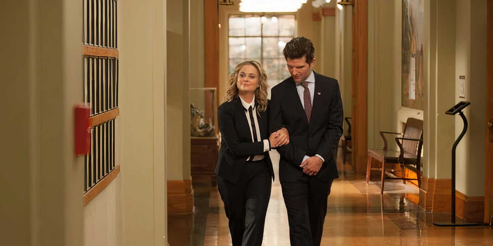 Adam Scott and Amy Poehler walk down a hallway in Parks and Recreation Season 7, Episode 12, "One Last Ride".