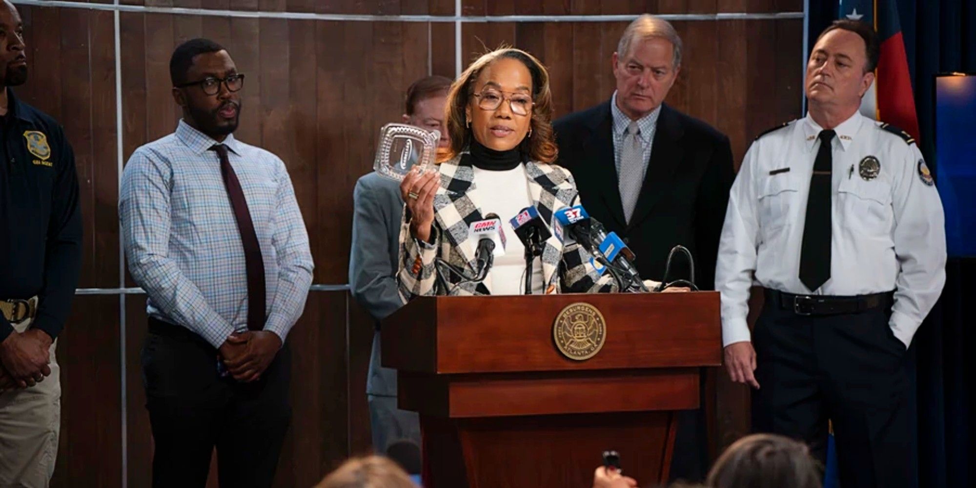 Amanda Wagner giving a press conference in the Season 3 finale of Will Trent.