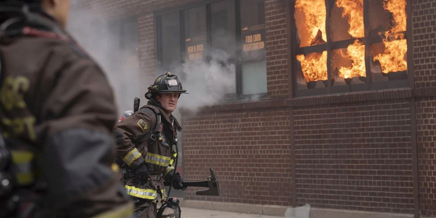 Carver (Jake Lockett) approaches a building on fire with a fire ax in the Chicago Fire Season 13 finale.