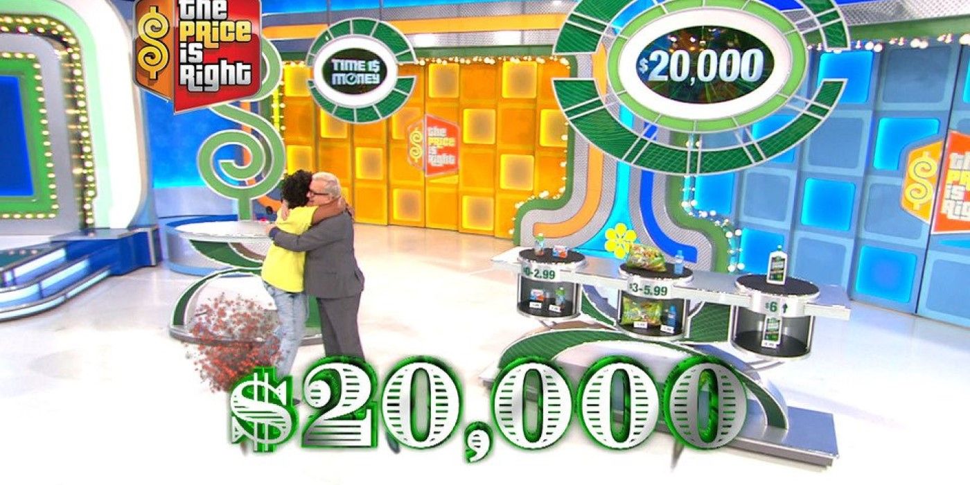 Contestant hugs Drew Carey after winning $20,000 playing Time is Money on The Price is Right.