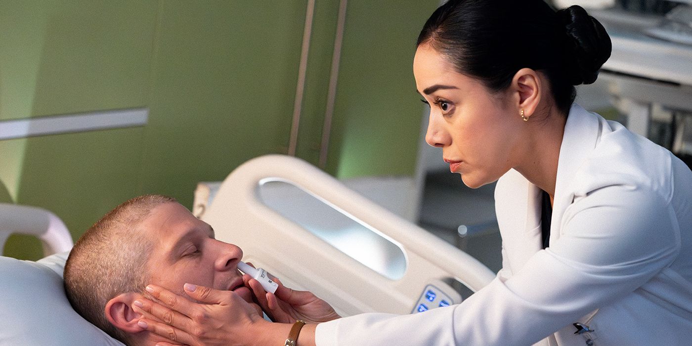 Aimee Garcia standing over Zach Gilford and giving him medicine in Criminal Minds.