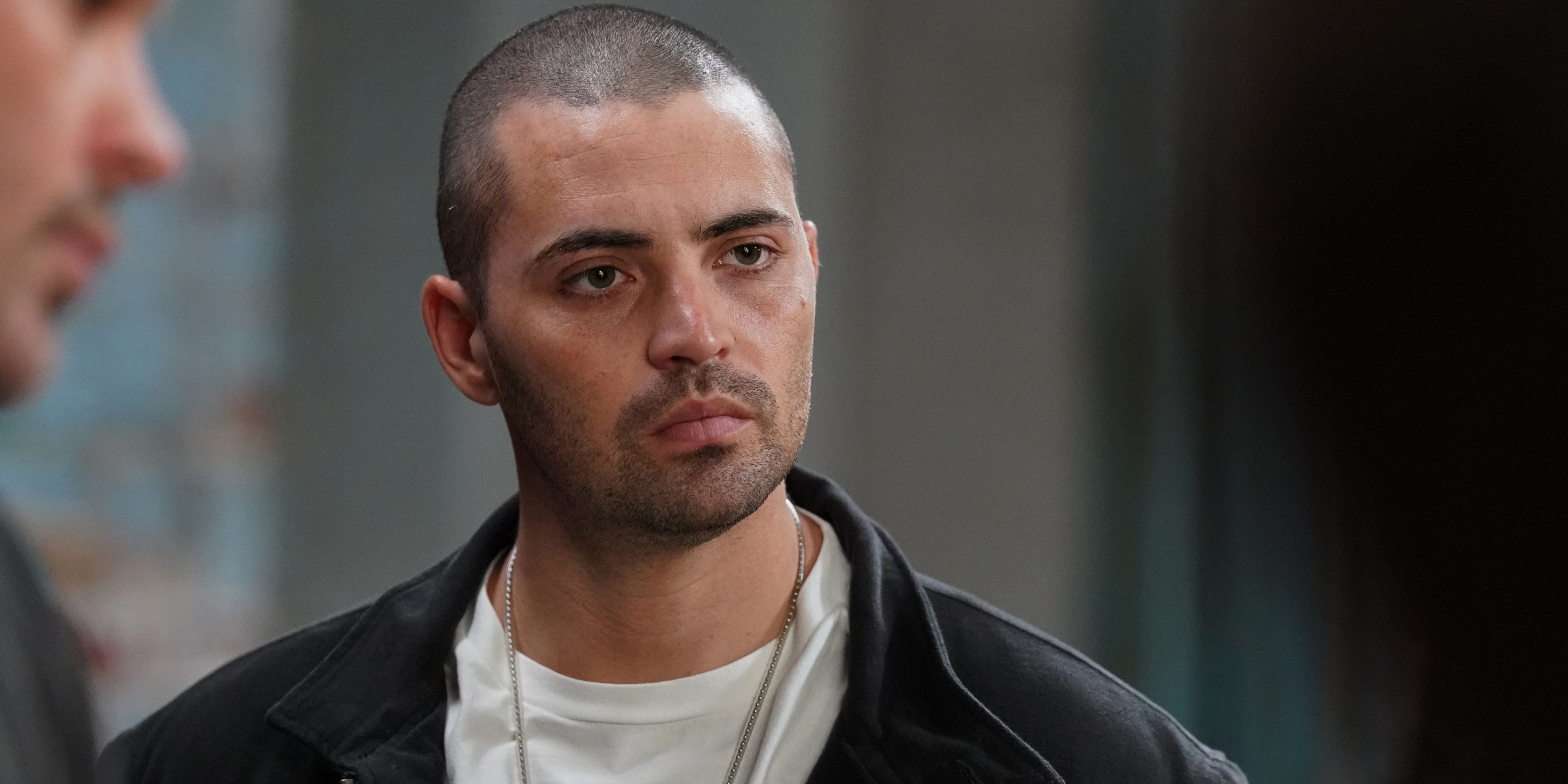 Dante Torres (Benjamin Levy Aguilar) in a black jacket and white t-shirt in Chicago P.D.