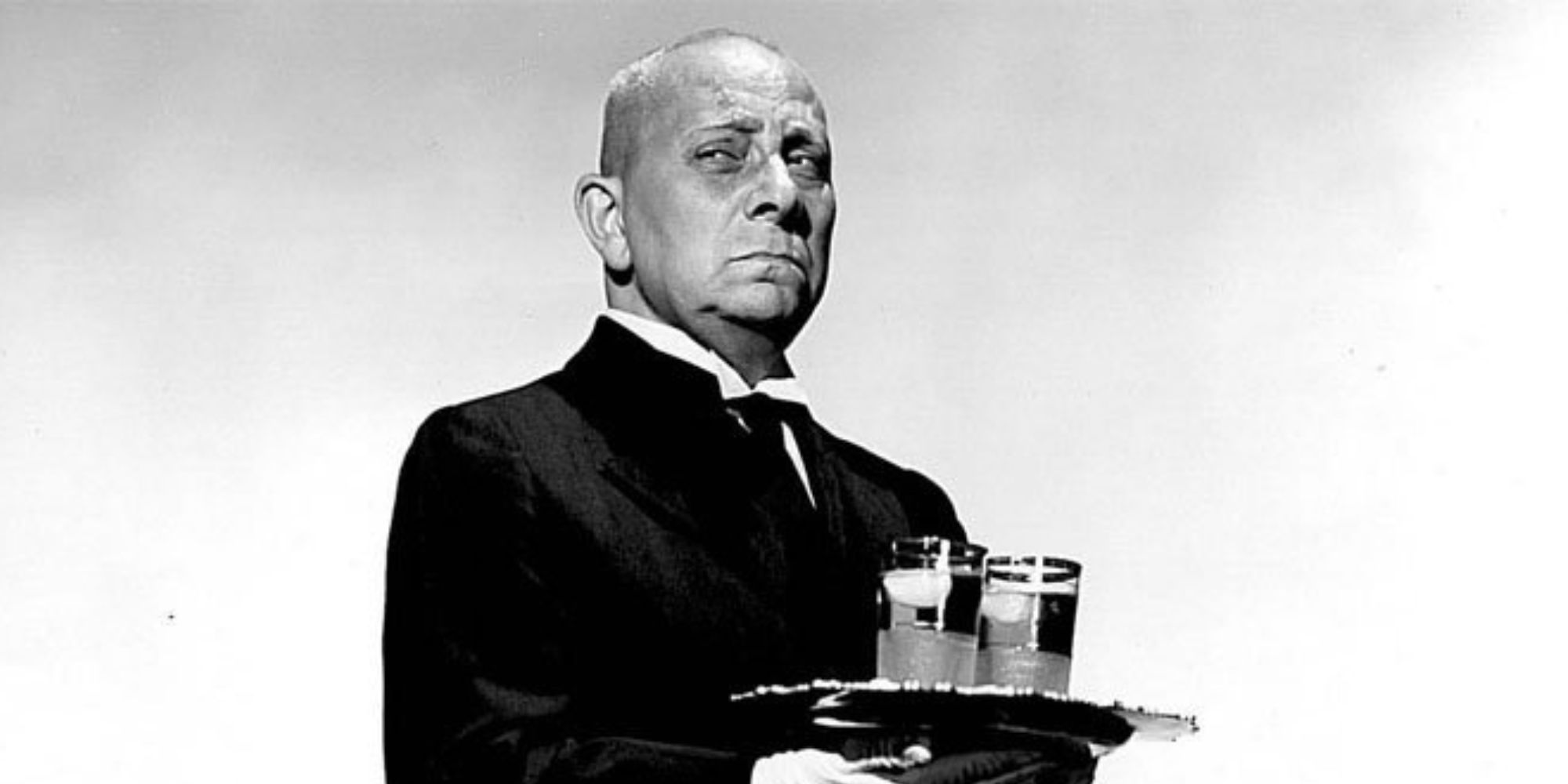 Erich von Stroheim as Max Von Mayerling carries a tray with drinks in a promo shot for Sunset Boulevard 1950.