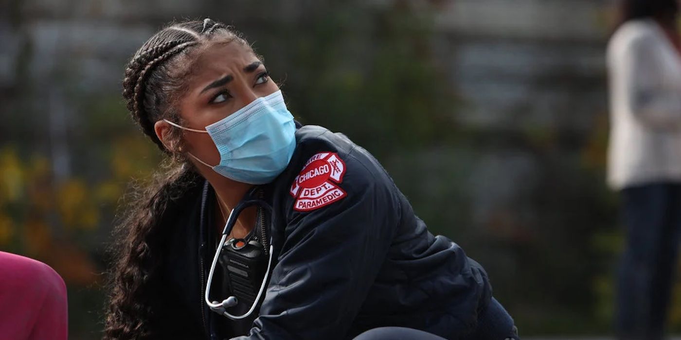 Gianna Mackey (Adriyan Rae), in mask, tends to a patient in Chicago Fire.