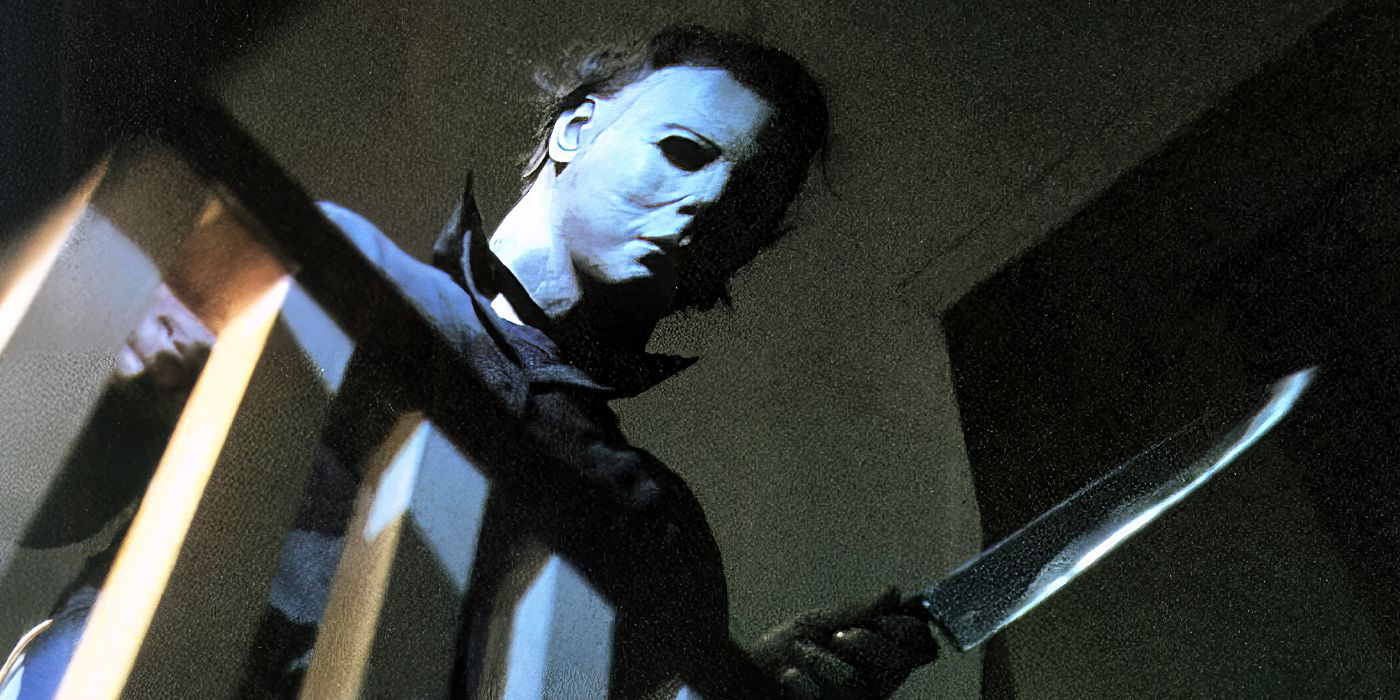 Michael Myers looking down from the stairs balcony holding a knife Halloween (1978)