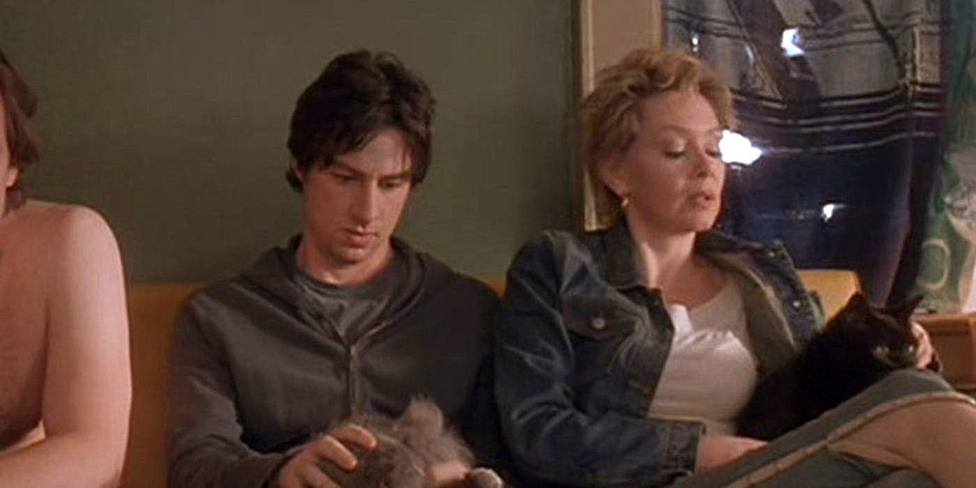 Zach Braff sits next to Jean Smart on a couch with another person with cats on their laps in Garden State.
