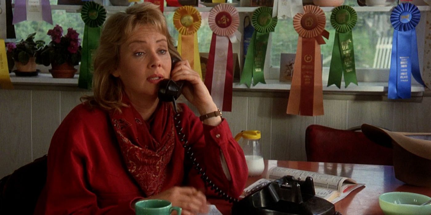 Jean Smart sits in a home office with many show ribbons around, talking on the phone in Homeward Bound.