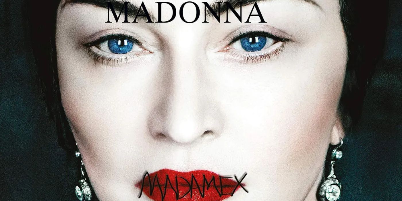 Madonna posing as a Frida Kahlo-esque personality for her album Madame X with a red lip stitched with black thread spelling the album's name