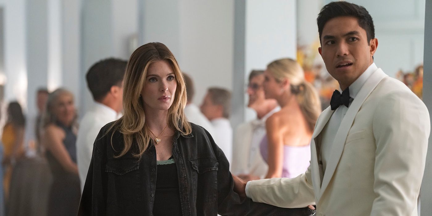 Meghann Fahy wearing a black jacket holding the arm of Trevor Salter wearing a white tuxedo in the Sirens finale