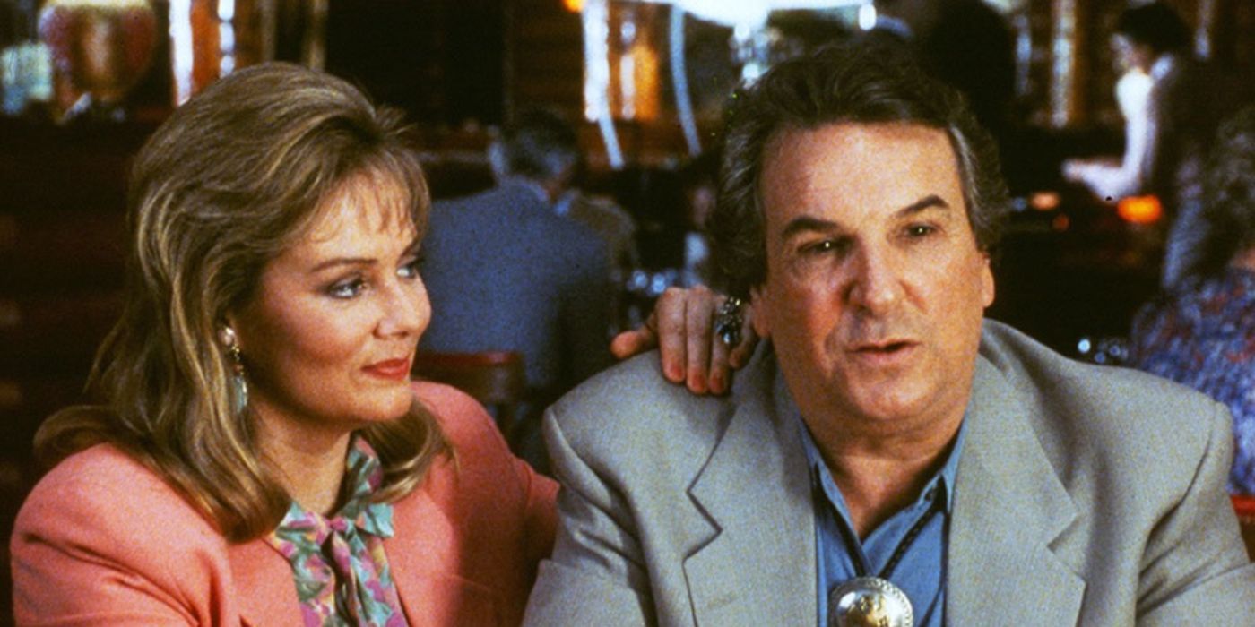 Danny Aiello and Jean Smart sit at a table together in Mistress.