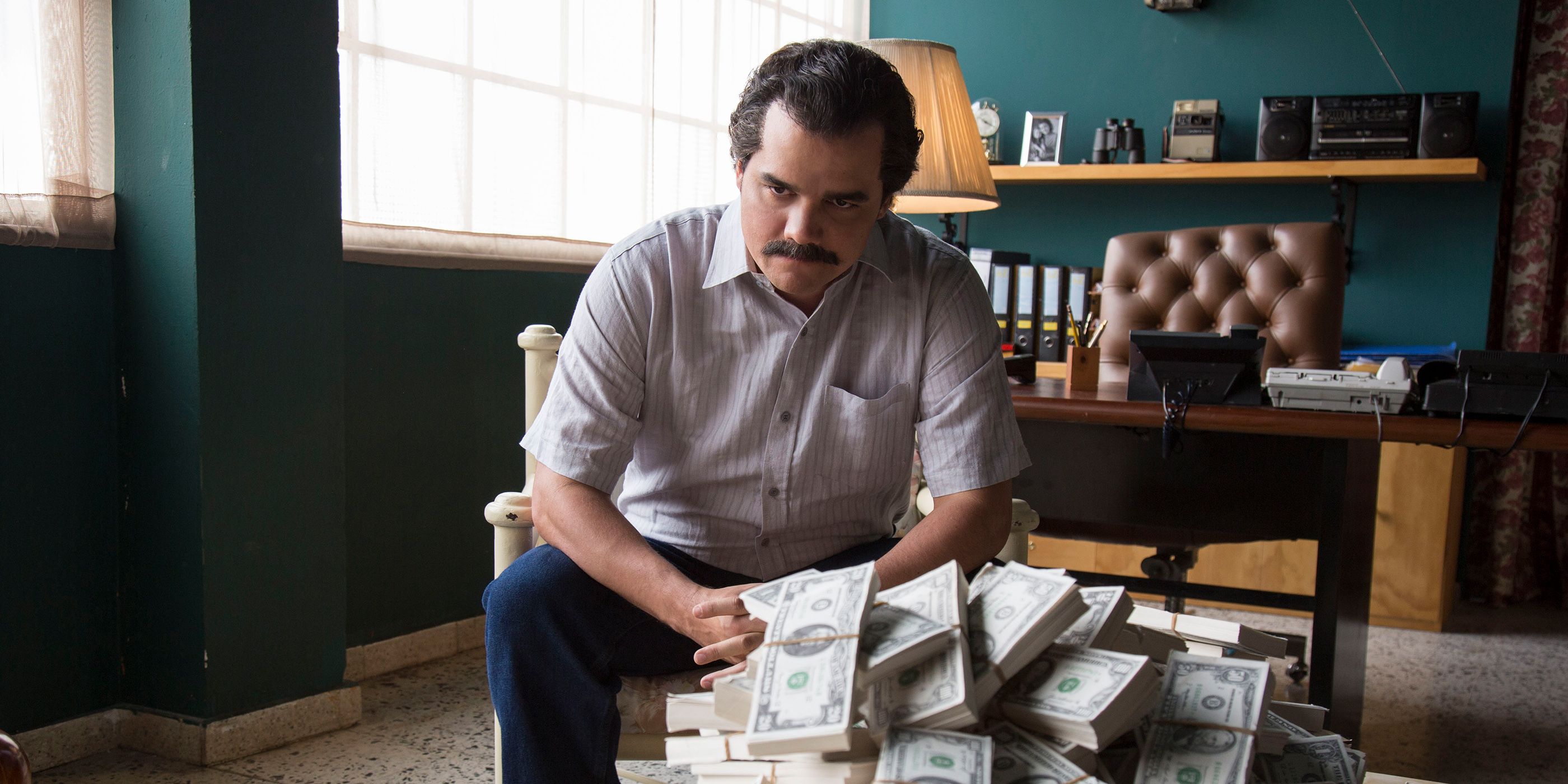 Wagner Moura as Pablo Escobar in a scene from Narcos sitting down