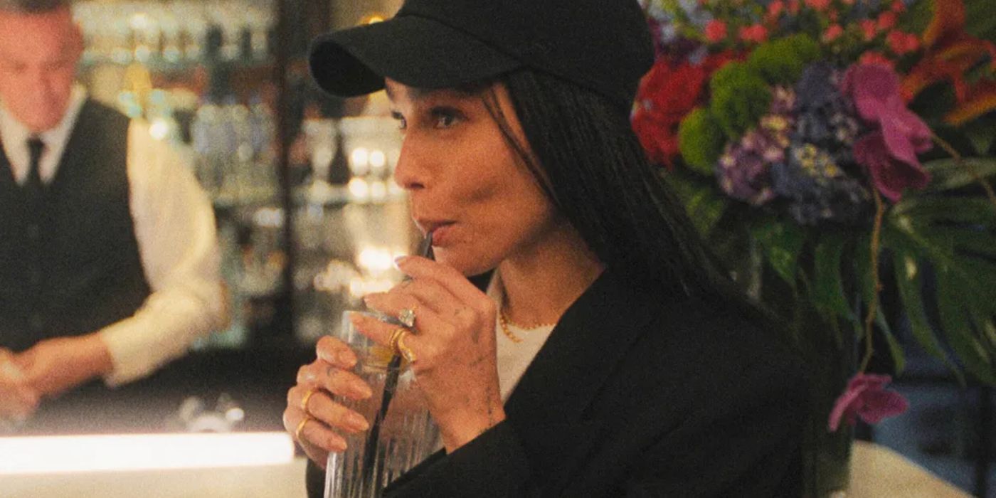 Zoe Kravitz in a baseball cap drinking a beverage through a straw at a restaurant in The Studio.