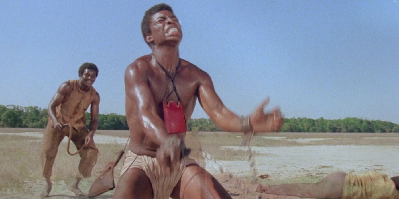 A slave with shackles around his hands is whipped in 'Roots'.