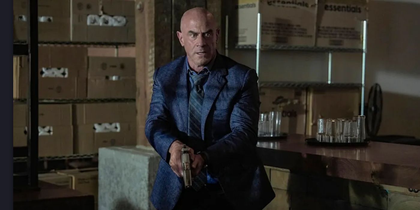 Christopher Meloni as Elliot Stabler walking in on something while armed in Law & Order: Organized Crime.