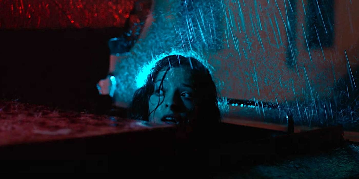 A young woman looks outside during a rainstorm in The Last Matinee. 
