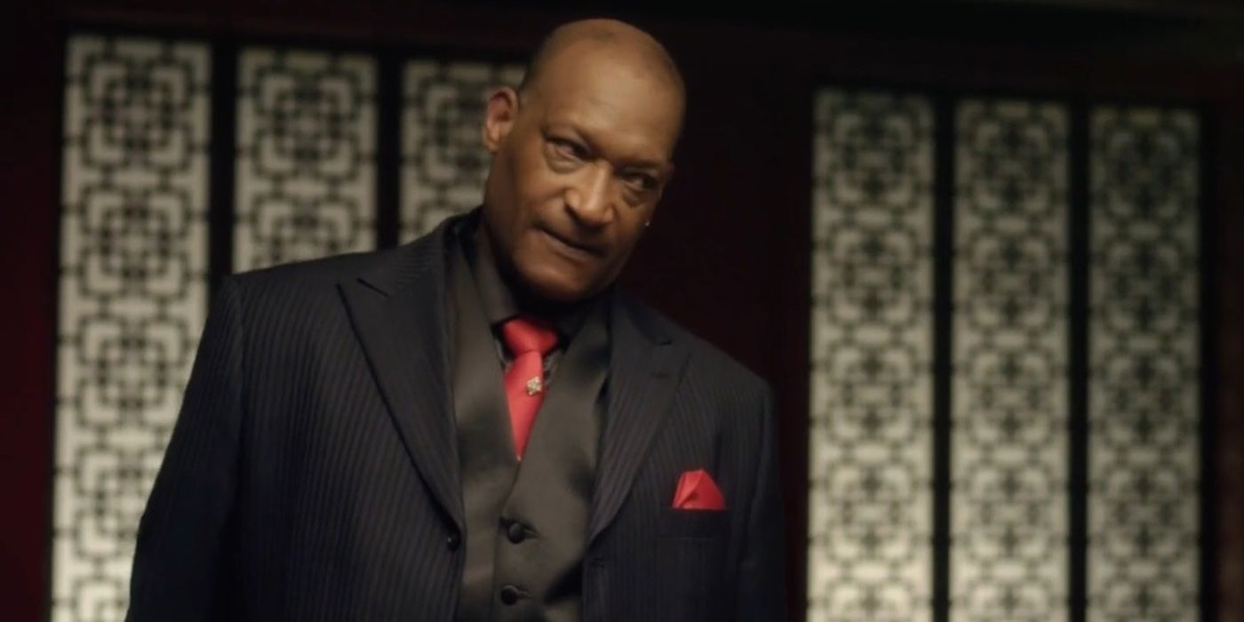 Tony Todd as Duke wearing a black suit and a red tie in 'Sushi Girl' (2012)
