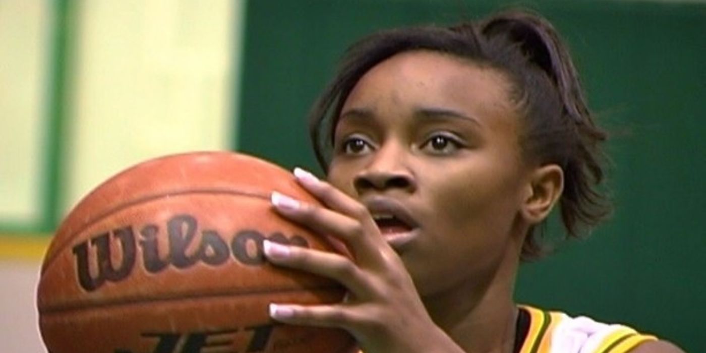 A basketball player holds a basketball during a game and prepares to make a play in The Heart of the Game.