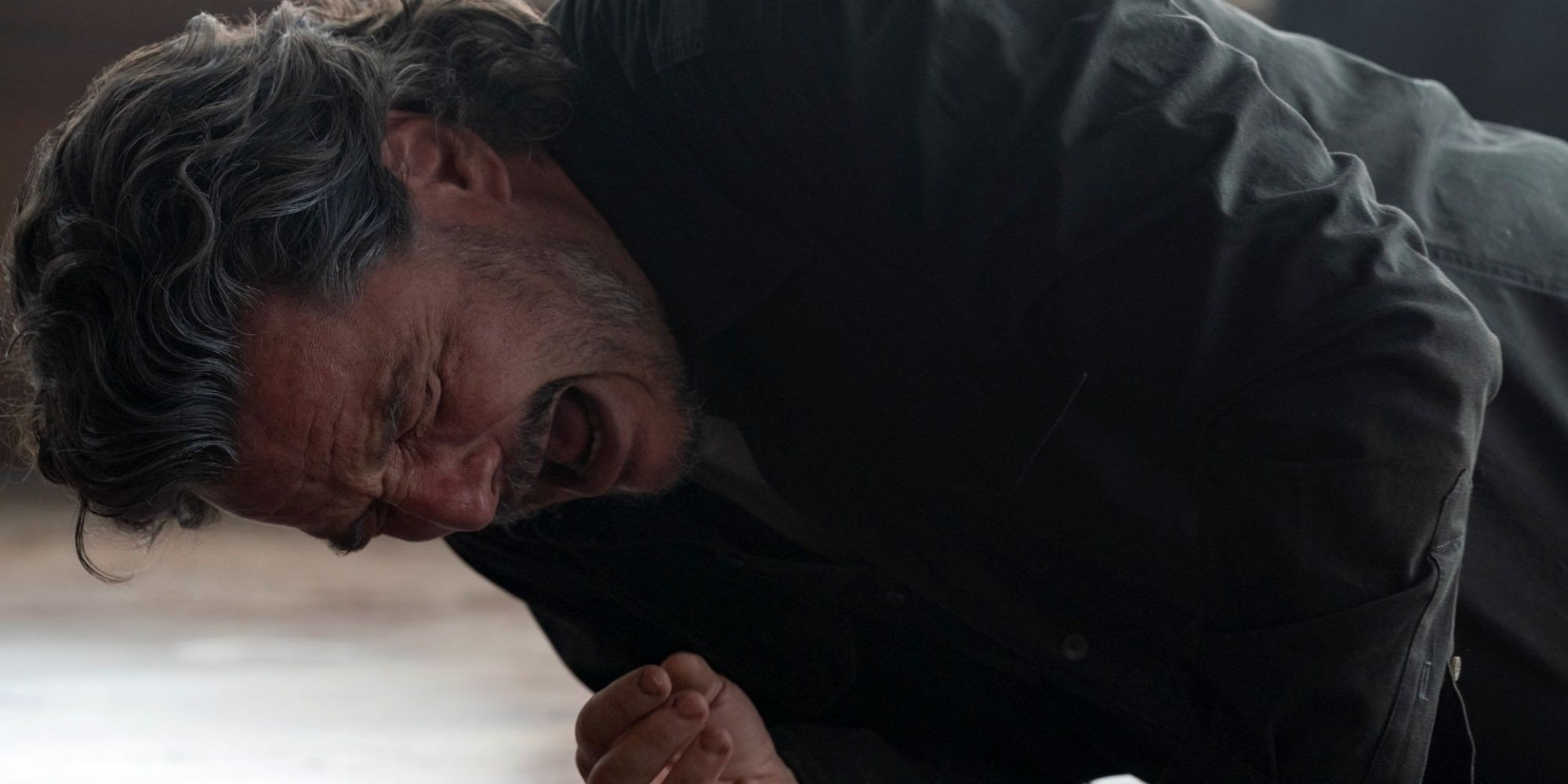 Pedro Pascal as Joel on the floor of the cabin in agony after getting hit by Abby in The Last of Us Season 2