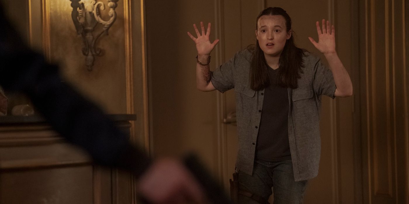 Bella Ramsey as Ellie, holding her hands up in surrender in The Last of Us Season 2 finale