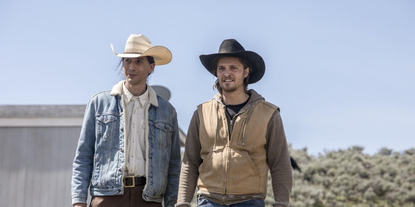 Tokala Black Elk e Luke Grimes em Yellowstone, fiquem no rancho e olhando para algo na frente deles