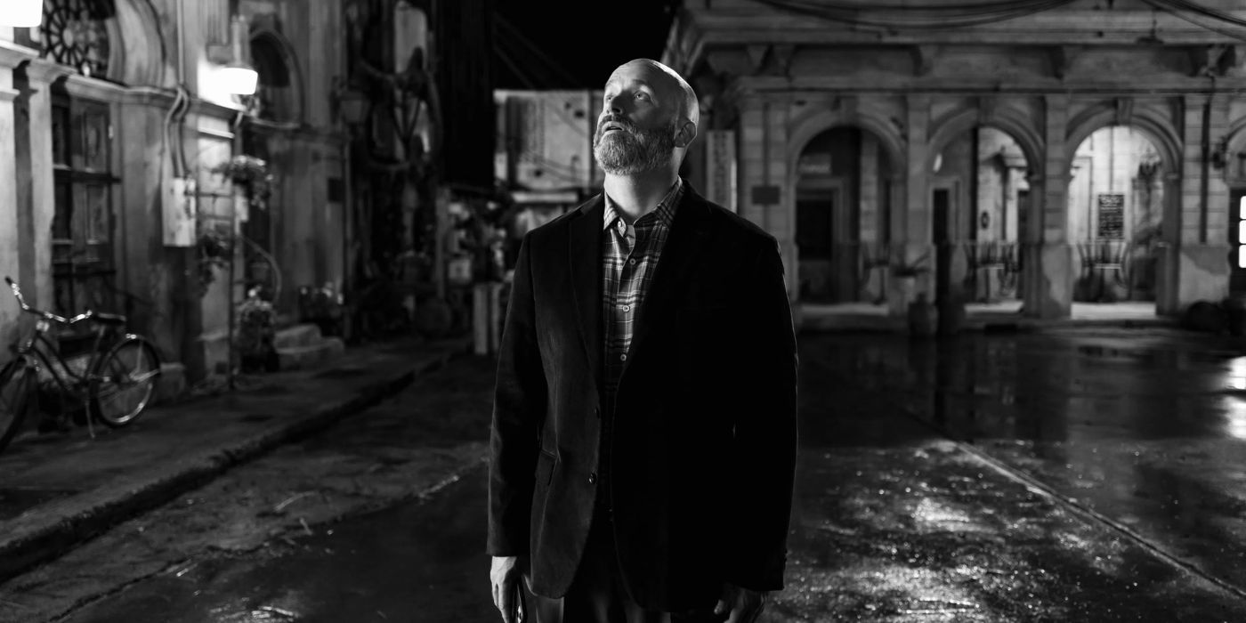Tom Segura walking down the streets of Paris in a black and white still from Bad Thoughts.
