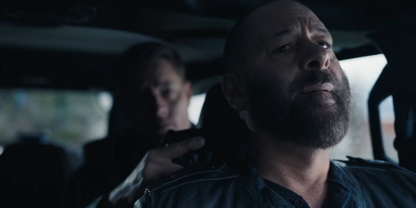 Colter Shaw (Justin Hartley) holds drug lord Ronnie Yates (Artine Tony Browne) at gunpoint in the 'Tracker' Season 2 finale "Echo Ridge."