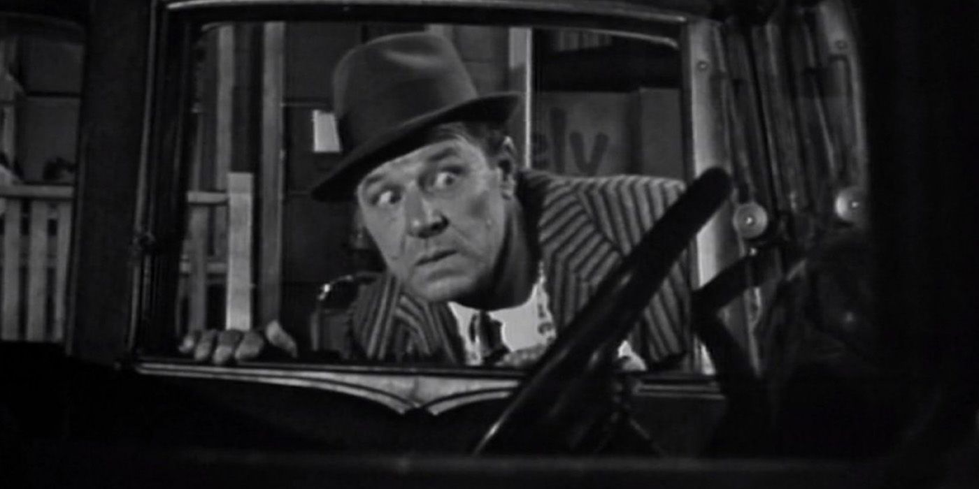 Jack Carson as Harvey Hunnicut looks through the window of a car in 'The Twilight Zone' episode "The Whole Truth."