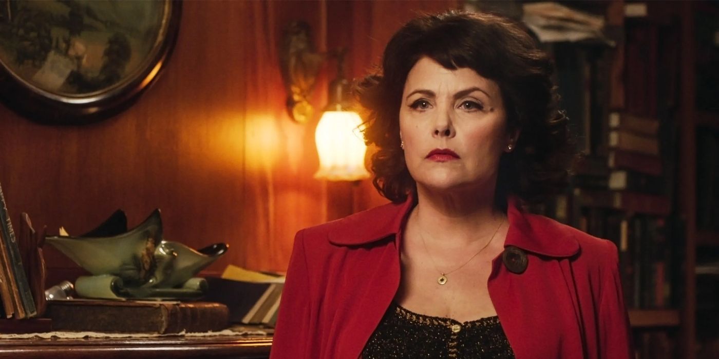 Audrey Horne (Sherilyn Fenn) looking frustrated and wearing a black blouse and red coat in Twin Peaks: The Return