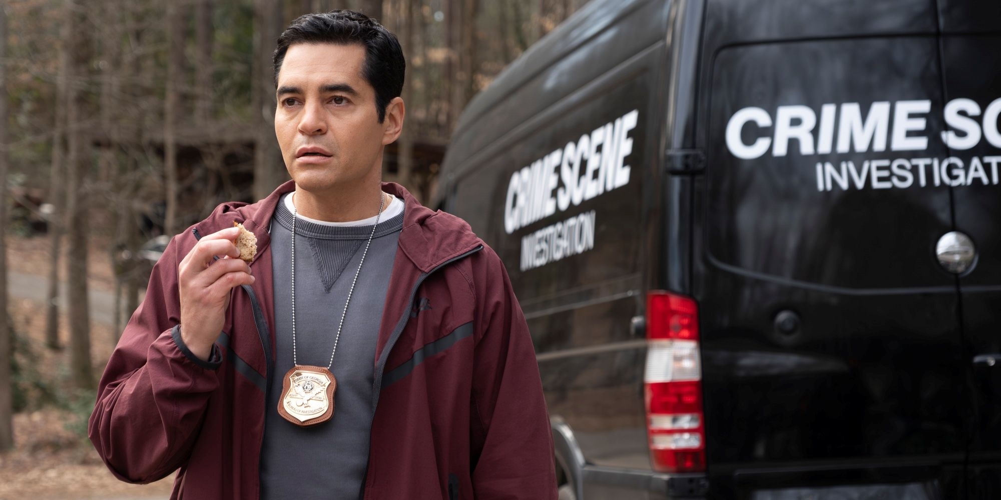 Ramón Rodríguez as Will standing in front of the crime scene van in Will Trent