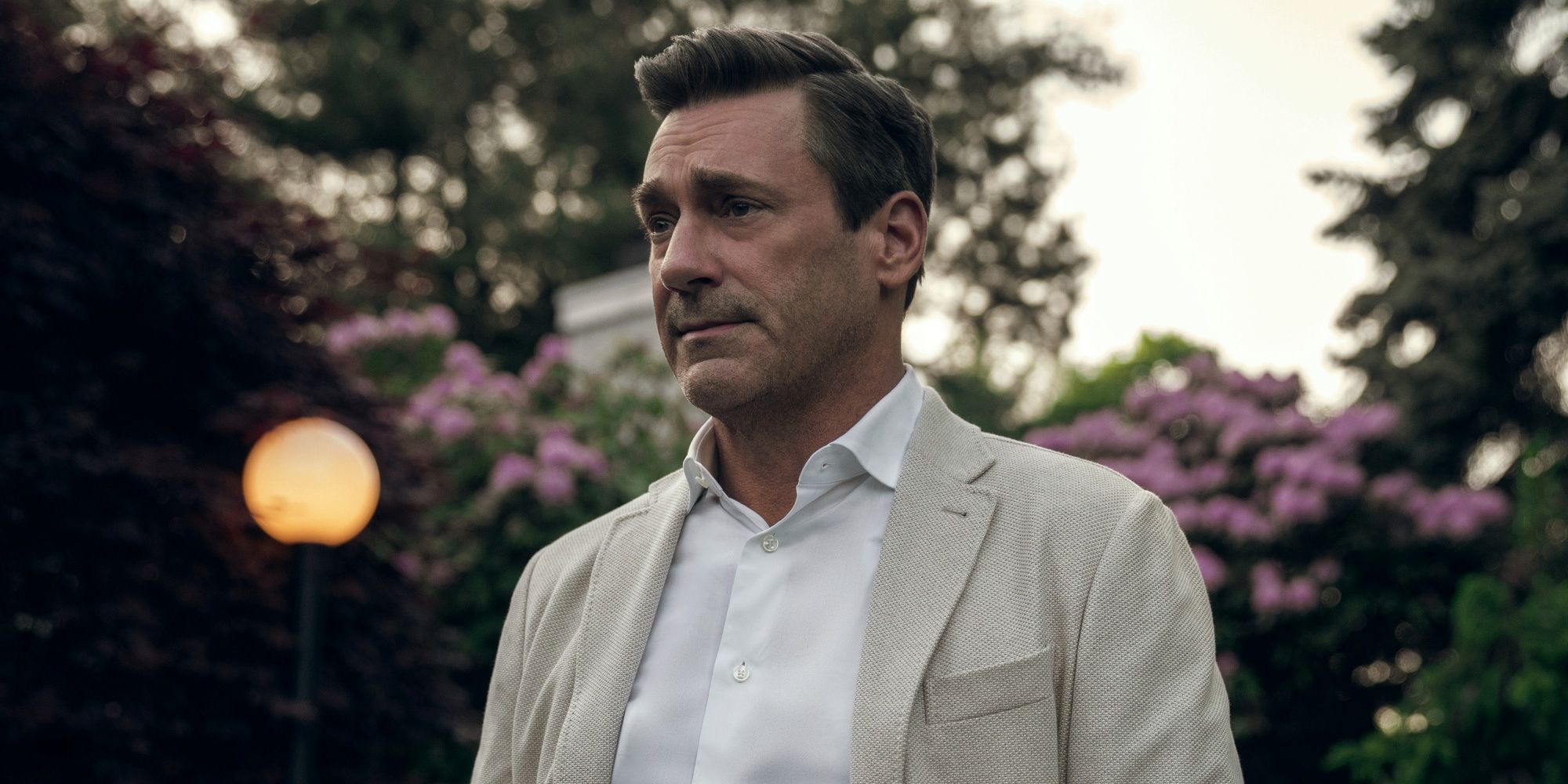 Jon Hamm as Coop in a cream-colored linen suit jacket and white button-down shirt in Your Friends & Neighbors