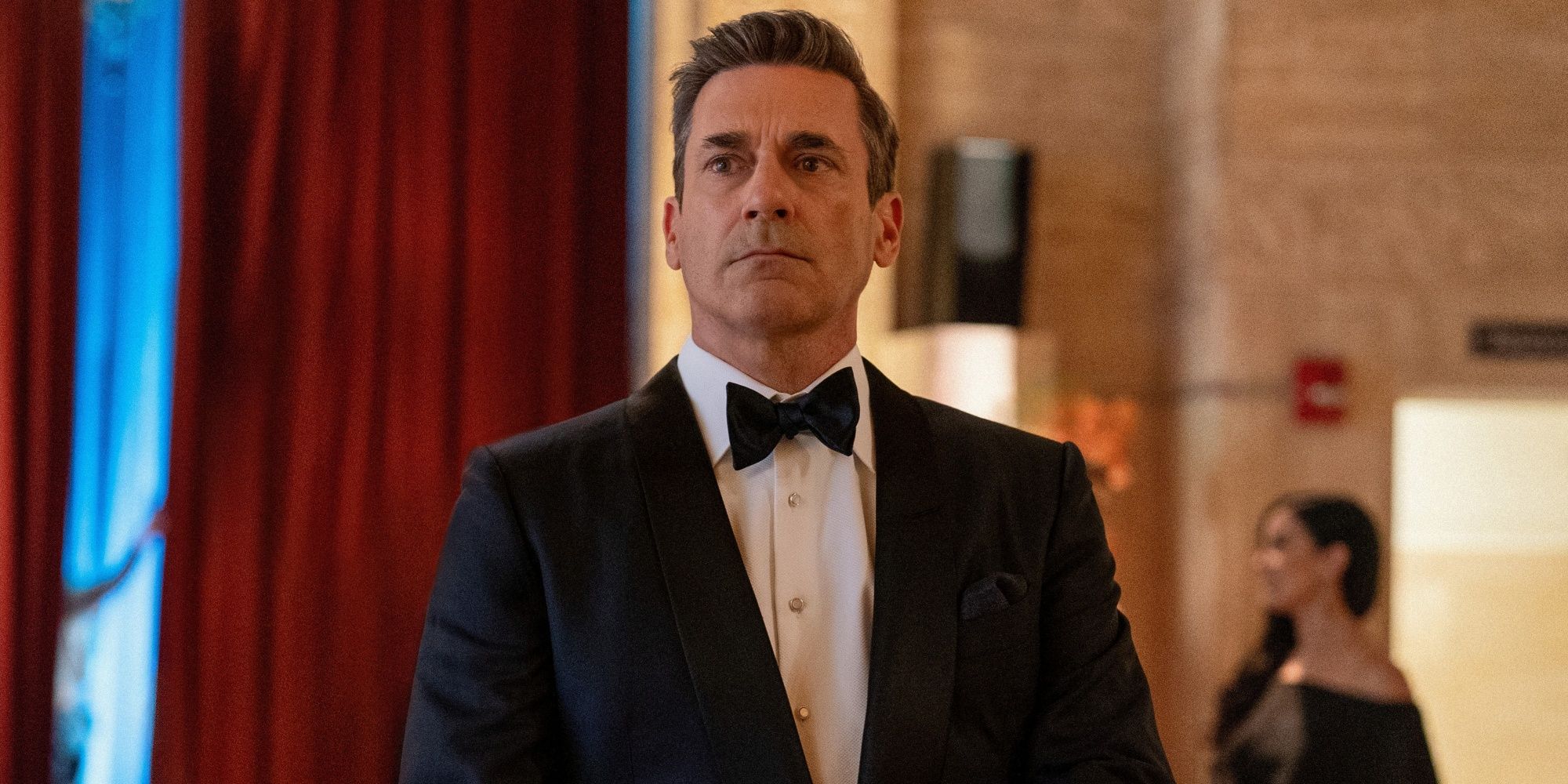 Jon Hamm as Coop looking serious in a tuxedo in Your Friends & Neighbors