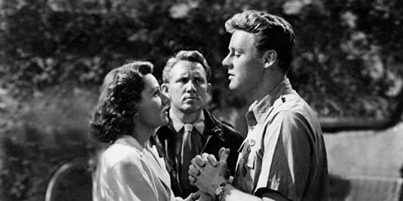 A couple looking at each other while another man watches them in A Guy Named Joe