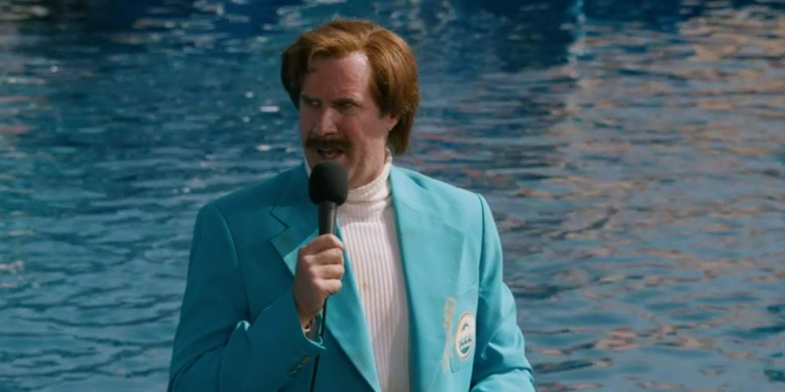 Will Ferrell as Ron Burgundy wearing a blue suit and speaking into a microphone at Seaworld in 'Anchorman 2: The Legend Continues'