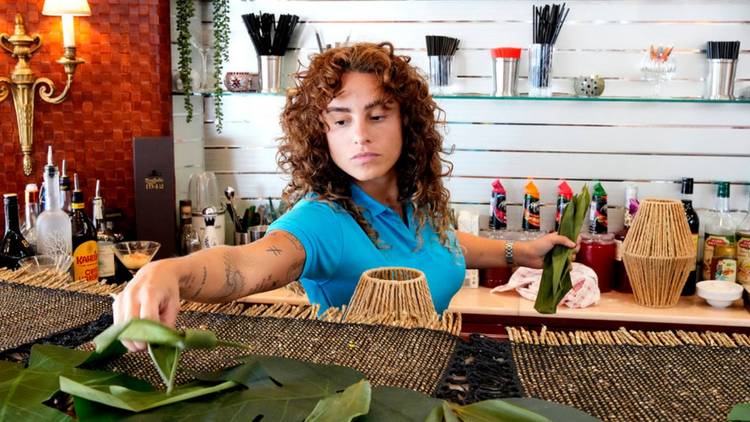 Stewardess Barbara Kulaif cleans the bar on 'Below Deck' Season 12.