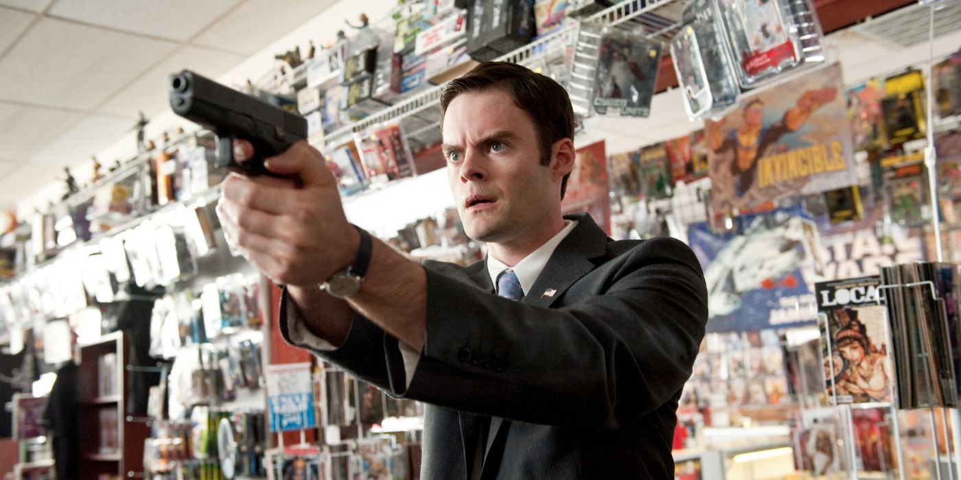 Bill Hader as agent Haggard pointing a gun at someone off-screen in Paul