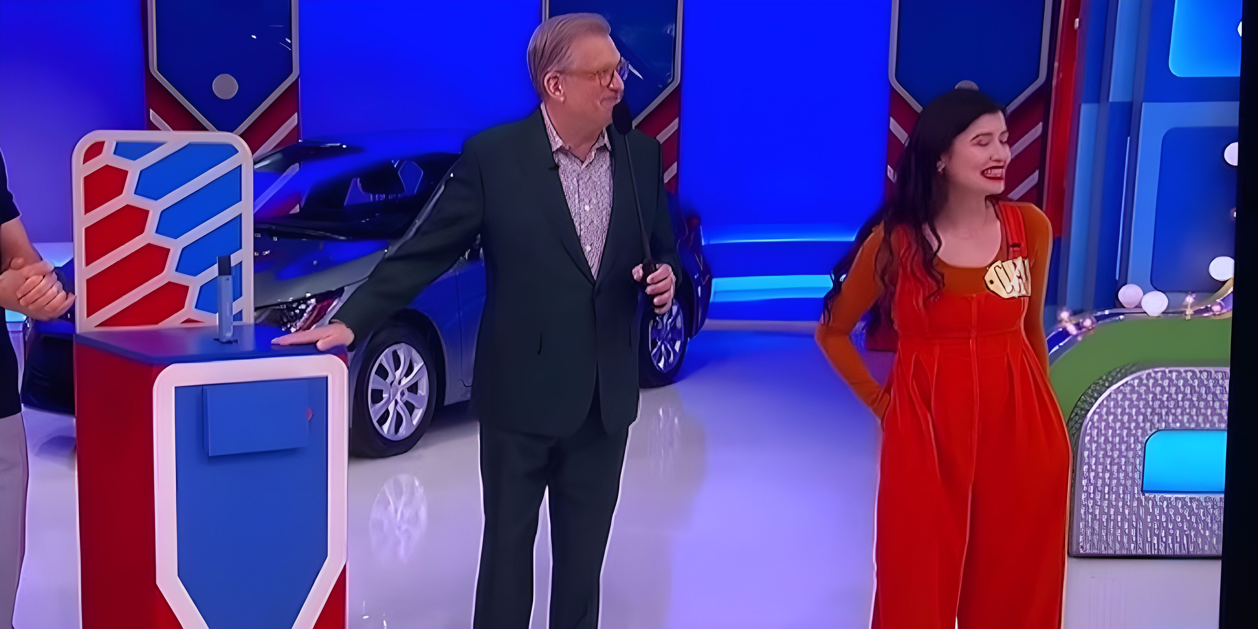 Drew Carey explains to contestant Claire Tongbalad how to play Five Price Tags on The Price Is Right.