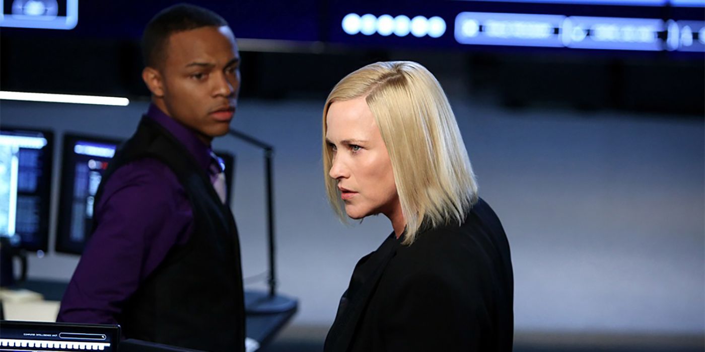 Patricia Arquette with a costar in an office staring intently in CSI: Cyber.