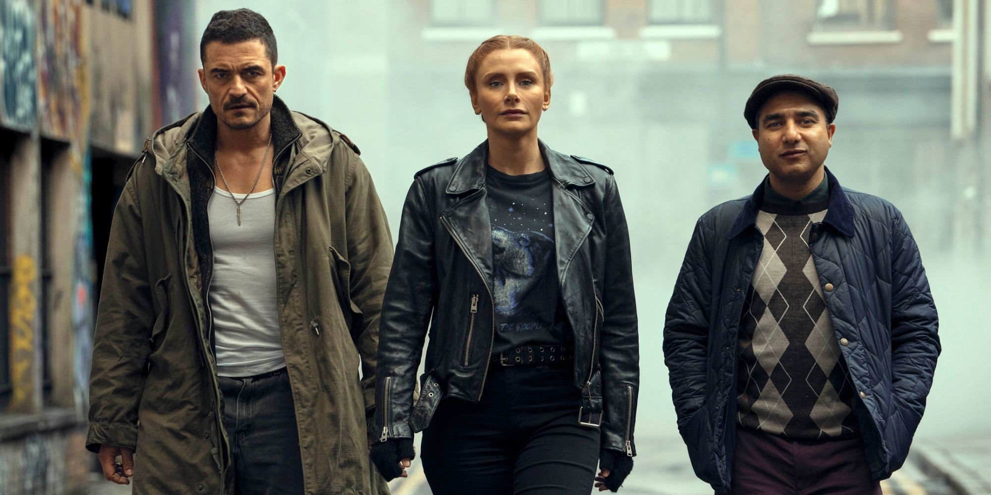Bryce Dallas Howard walking down the street between Orlando Bloom and Nick Mohammed in Deep Cover