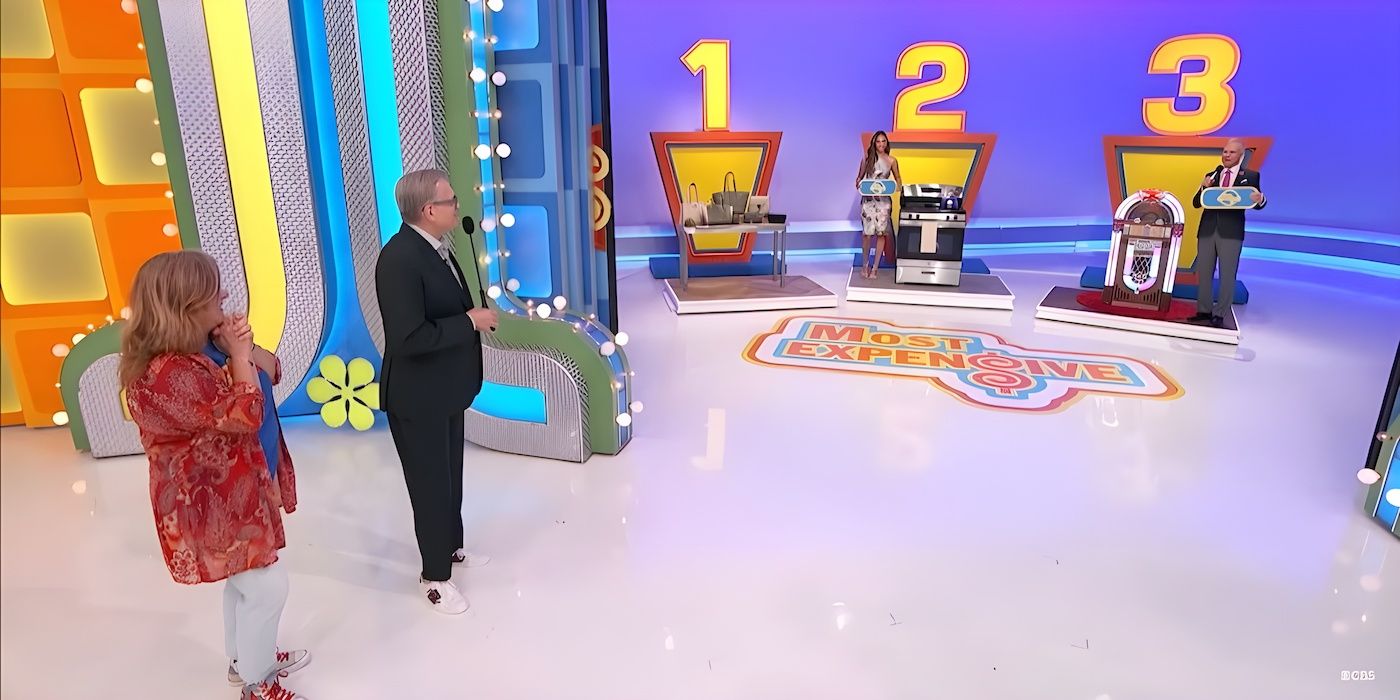 Drew Carey shows the prizes for "Most Expensive" to contestant Mary Carrion on The Price Is Right.