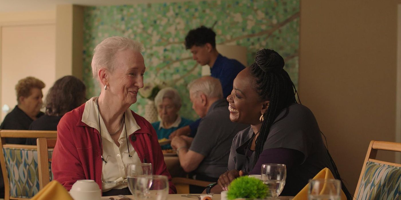 Kathleen Chalfant and Carolyn Michelle Smith as Ruth and Vanessa, sitting at a table and smiling at each other in 'Familiar Touch'