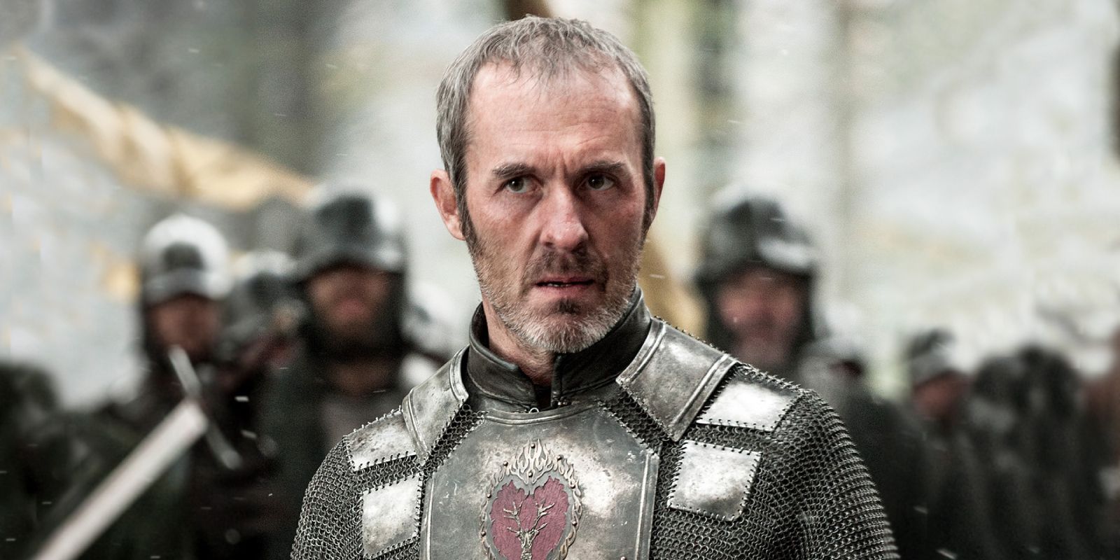 Stannis Baratheon looks concerned and wears armor in Game of Thrones.
