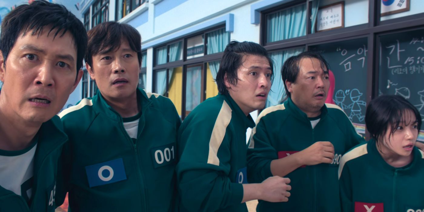 Gi-hun and teammates Young-il (The Frontman), Dae-ho, Jung-bae, and Jun-hee in Pentathlon look horrified at an off screen execution in Squid Game 2