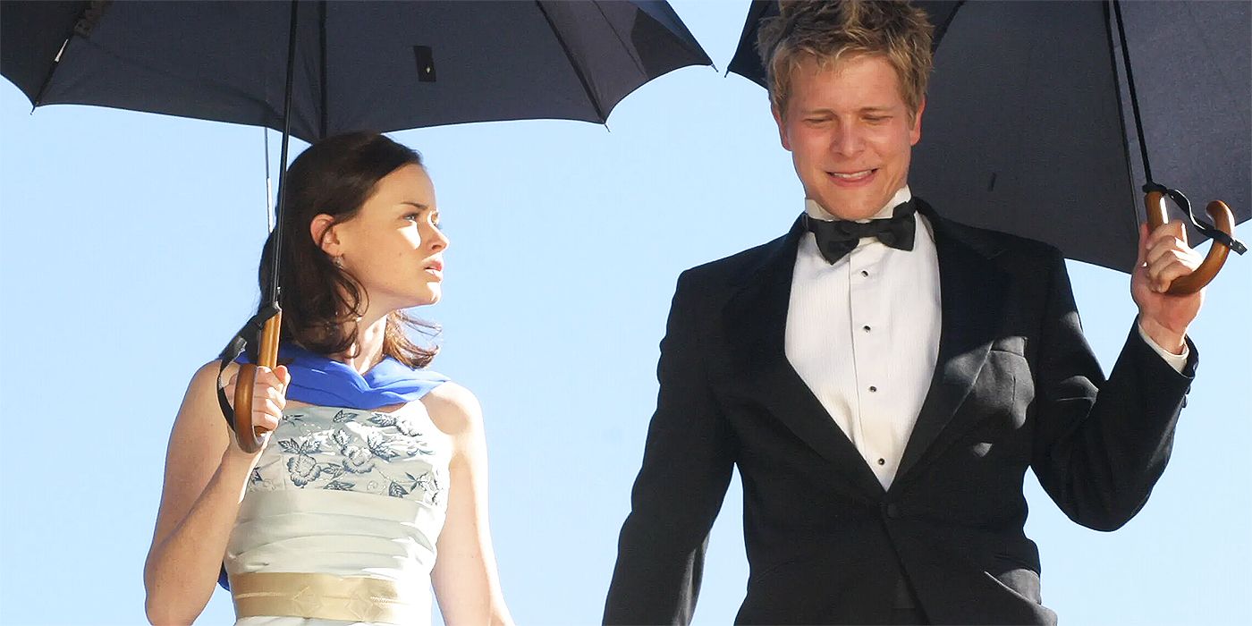 Rory (Alexis Bledel) and Logan (Matt Czuchry) holding hands and umbrellas in Gilmore Girls