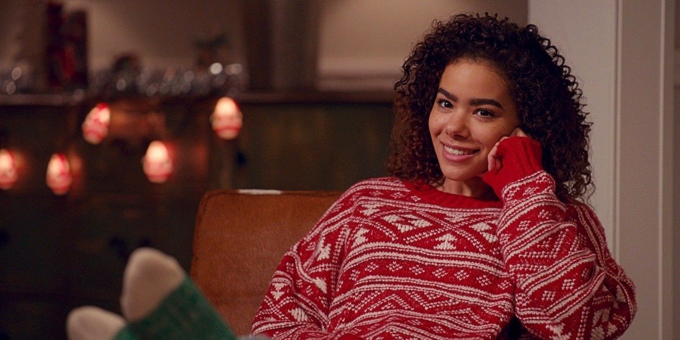 Antonia Gentry as Ginny Miller wearing a Christmas sweater and smiling in Ginny and Georgia Season 2.