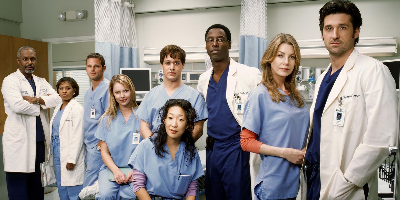 The cast of Grey's Anatomy standing in a hospital area.