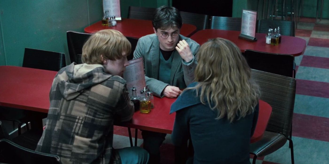Harry, Ron, and Hermione sit at a cafe and talk in one of the Harry Potter and the Deathly Hallows films.